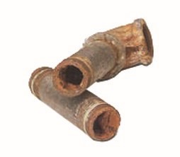 Two sections of cast iron pipes. The ends of the pipes are rusting away.